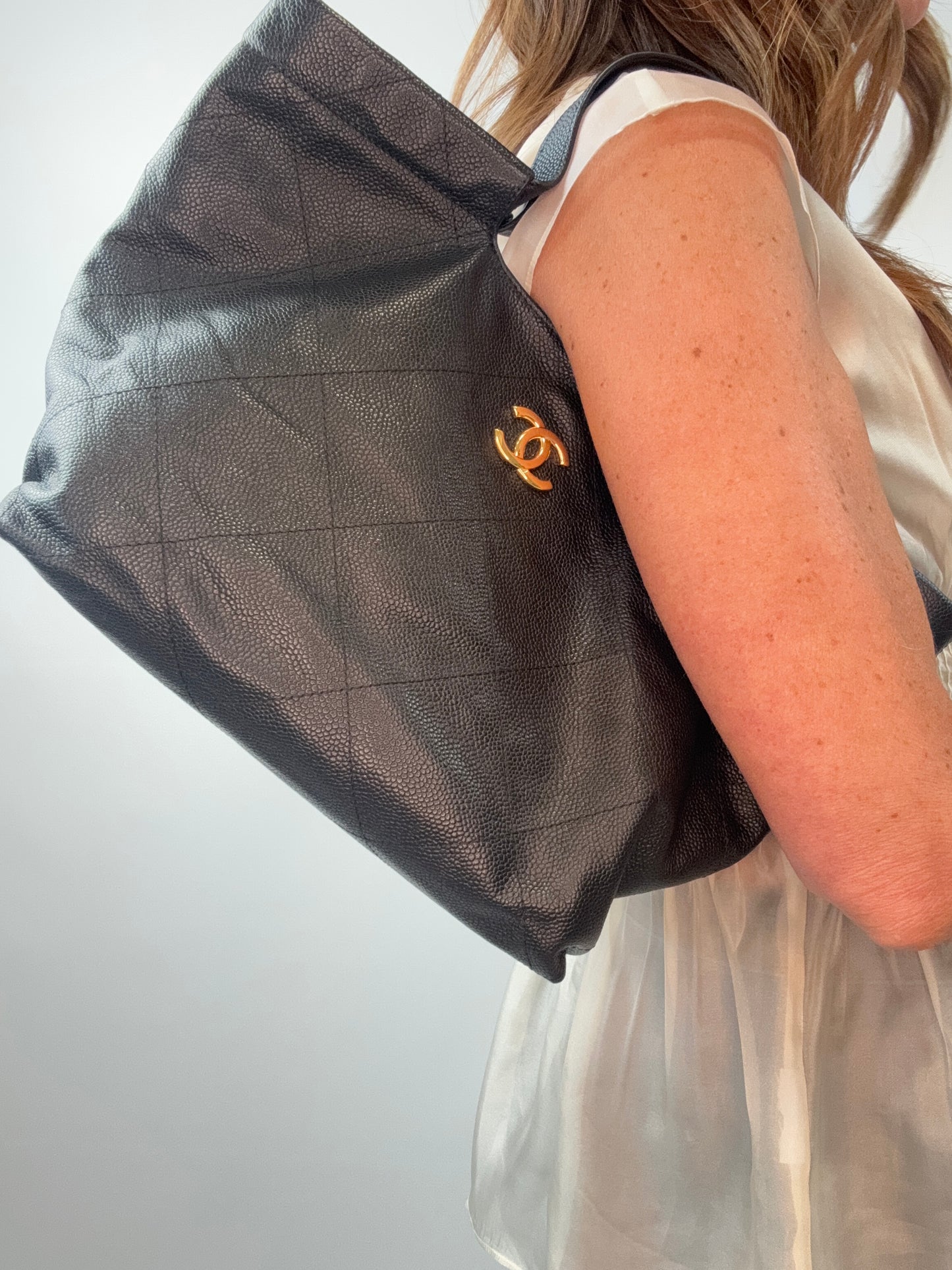 Chanel CC Quilted Caviar Leather Shopping Tote modeled 2
