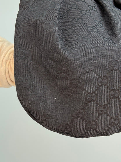 Gucci bag in black GG canvas with studded detailing and a bamboo handle.
 Back Left Corner