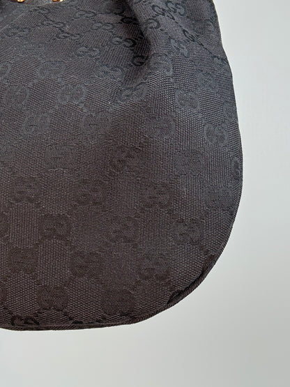Gucci bag in black GG canvas with studded detailing and a bamboo handle.
Back Right Corner