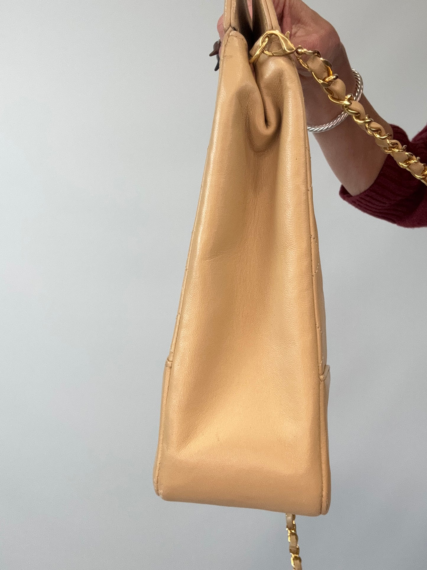 Chanel Quilted Lambskin 31 Shopping Tote in Beige left side of handbag