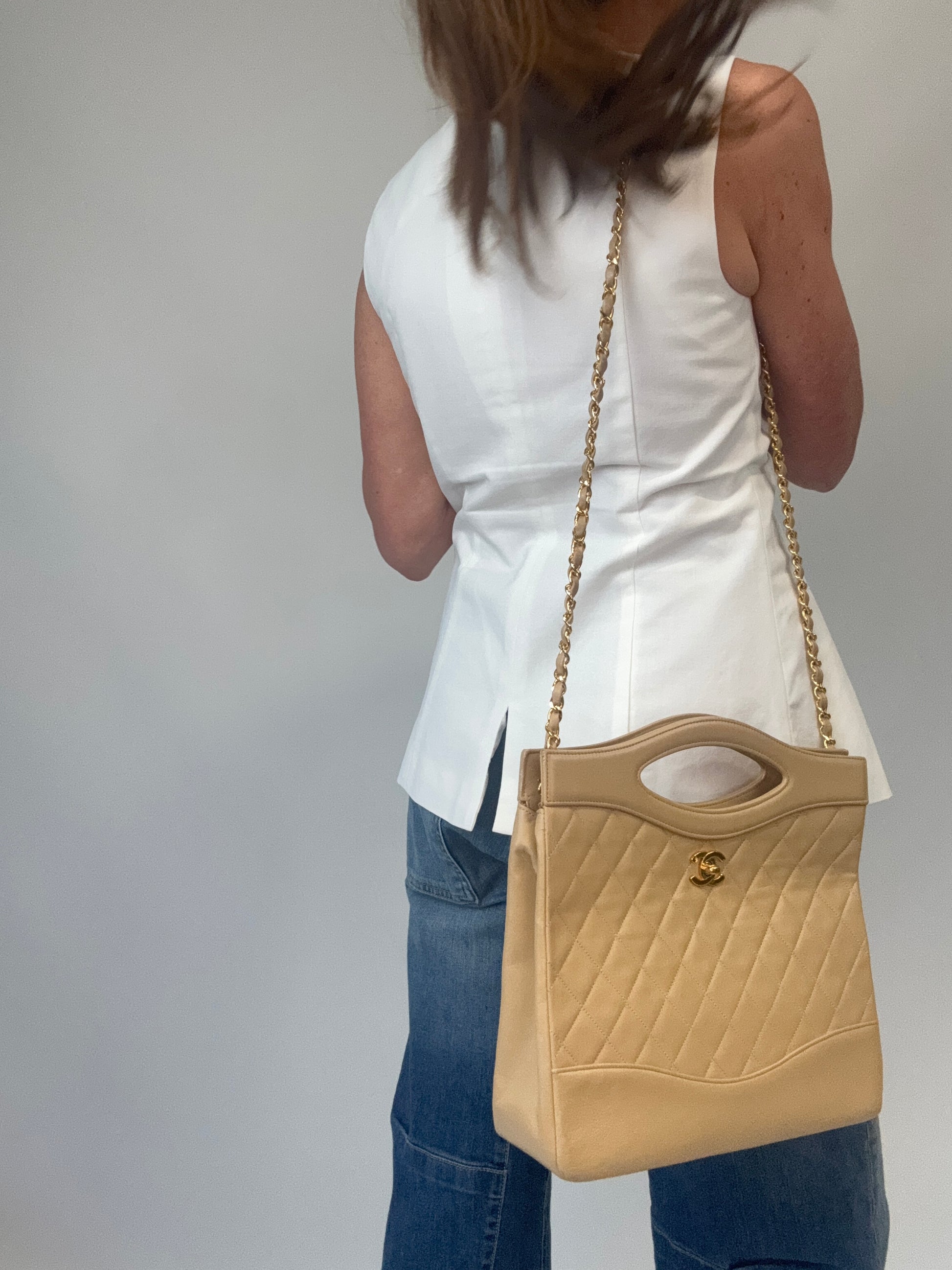 Chanel Quilted Lambskin 31 Shopping Tote in Beige modeled 3