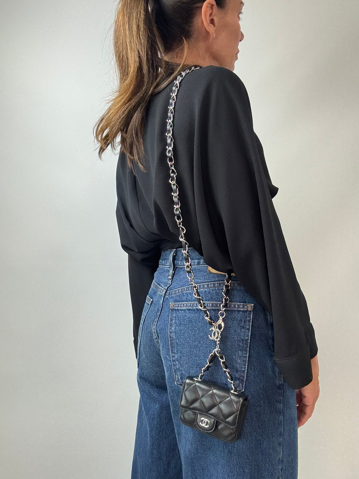 Chanel Quilted Lambskin Mini Flap Belt Bag modeled 5