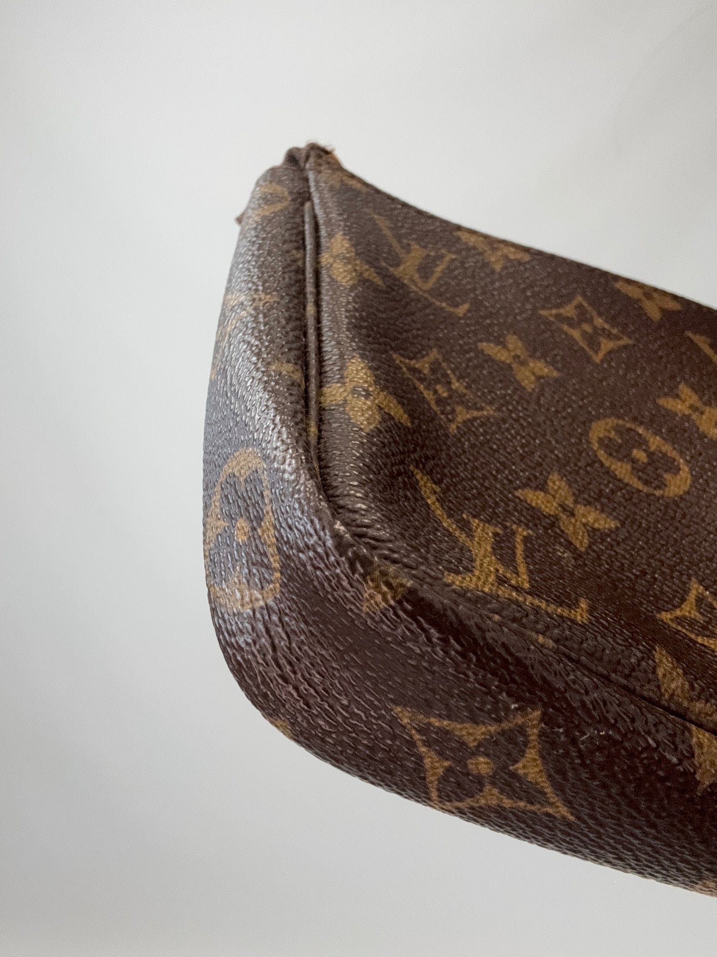 Louis Vuitton Monogram Pochette front left bottom corner