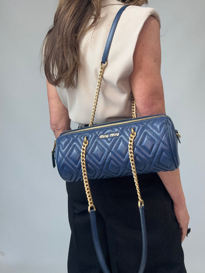 Miu Miu Diamond Quilted Cylinder Bag in Blue modeled 2