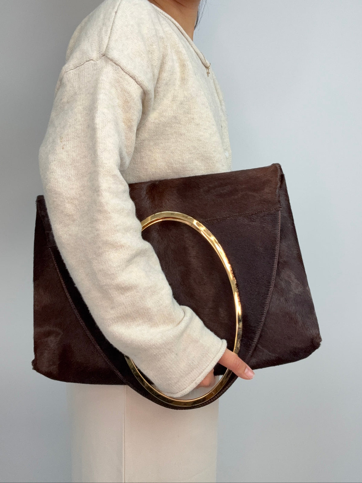 Gucci by Tom Ford oversized shoulder bag in brown pony hair from the Fall/Winter 1996 runway collection. Folded on Model
